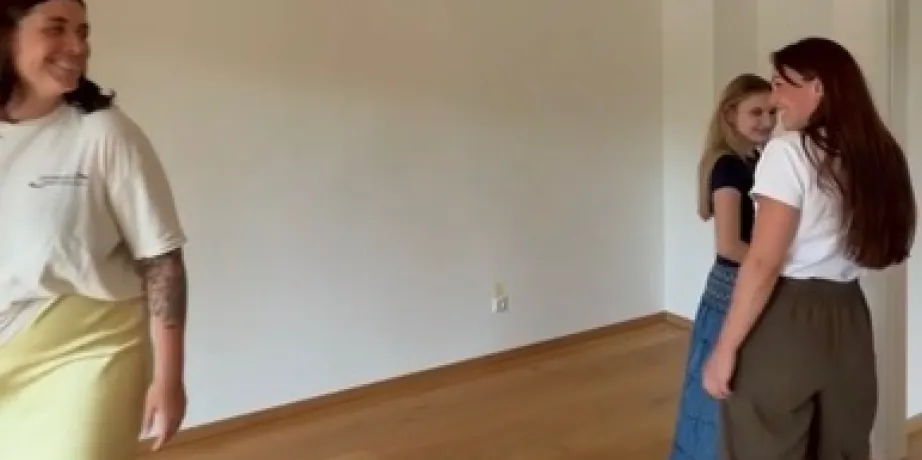 Three colleagues in an empty apartment on new oak flooring