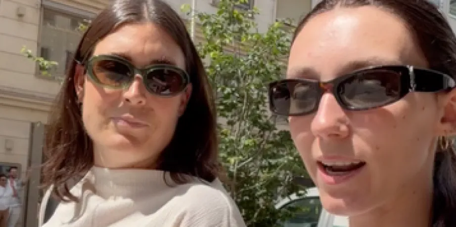 Two colleagues in sunglasses on a sunny street